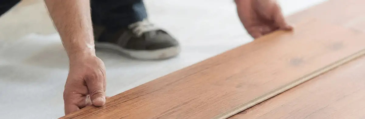 A professional installing laminate flooring in Newark, NJ